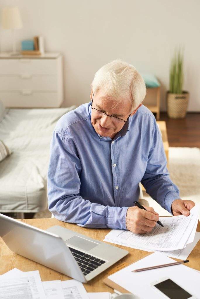 senior man filling application at home 2023 11 27 04 52 35 utc min